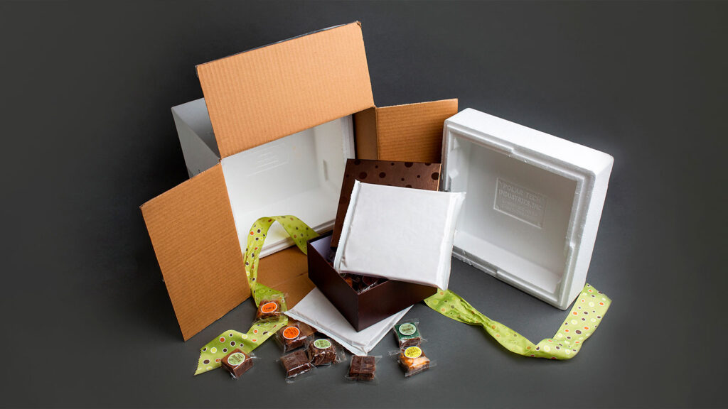 Open box containing packaged brownies and ThermaBrick Refrigerant Bricks.