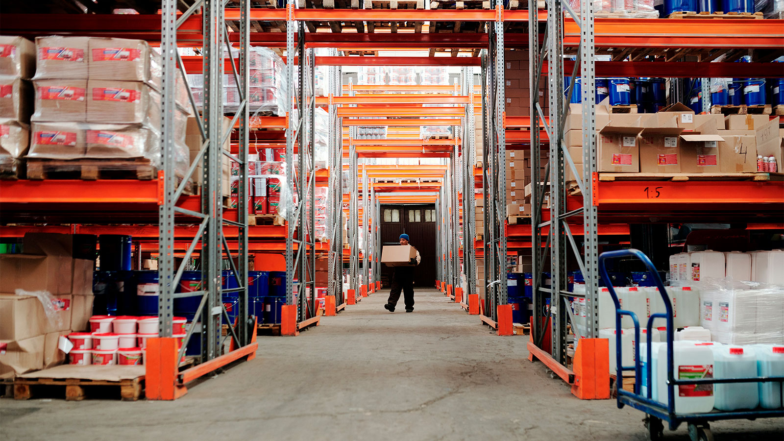 A man carrying a box through a warehouse