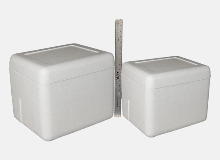 Two styrofoam boxes side by side with a ruler between them.